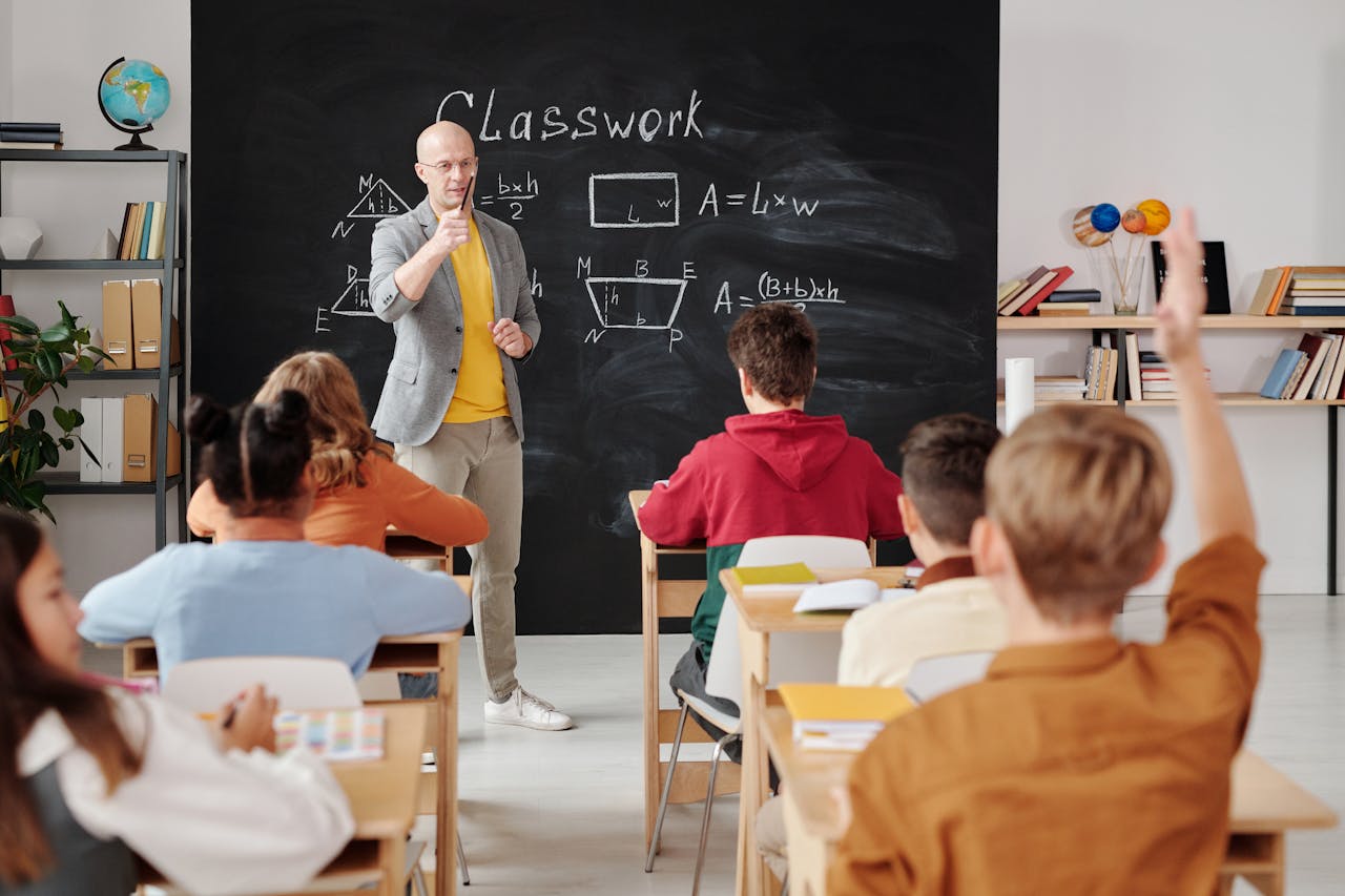 Teacher explaining geometry as students engage in a modern classroom setting.